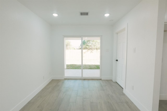 spare room with light hardwood / wood-style floors