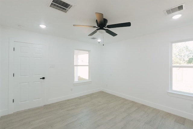 spare room featuring ceiling fan and light hardwood / wood-style flooring