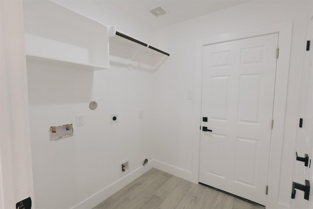 laundry area featuring electric dryer hookup, light hardwood / wood-style floors, gas dryer hookup, and hookup for a washing machine