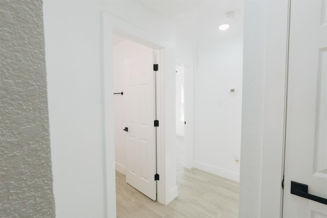 corridor with light wood-type flooring