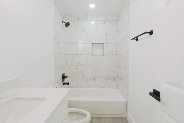 full bathroom with vanity, toilet, and tiled shower / bath