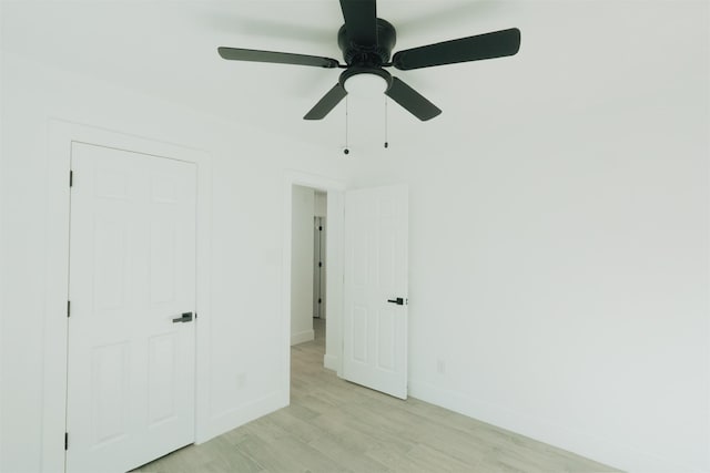 unfurnished bedroom featuring a closet, light hardwood / wood-style flooring, and ceiling fan