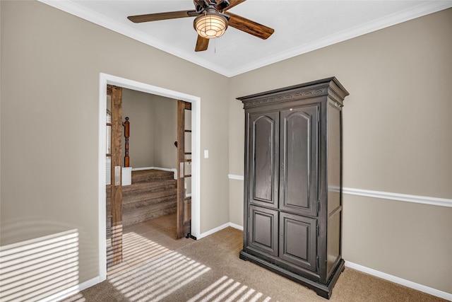 interior space with ceiling fan, crown molding, and light carpet