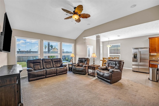 carpeted living room featuring ornate columns, ceiling fan, and lofted ceiling