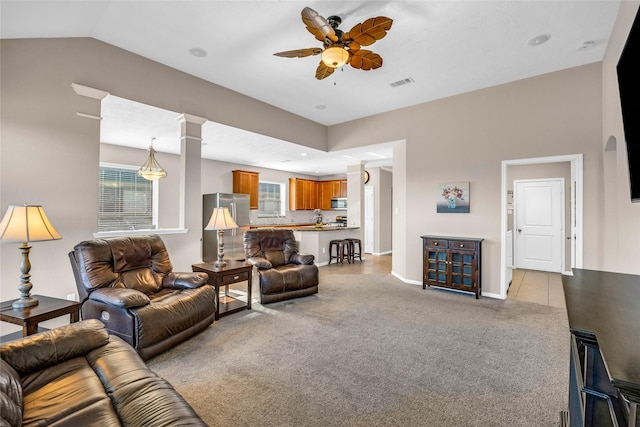 living room featuring ceiling fan, light colored carpet, and vaulted ceiling