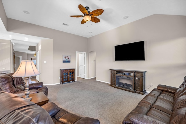 living room featuring ceiling fan, carpet, and vaulted ceiling