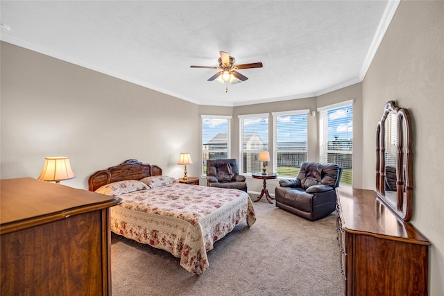 carpeted bedroom featuring multiple windows, ceiling fan, and ornamental molding