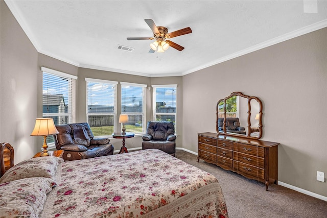 carpeted bedroom featuring ceiling fan and crown molding