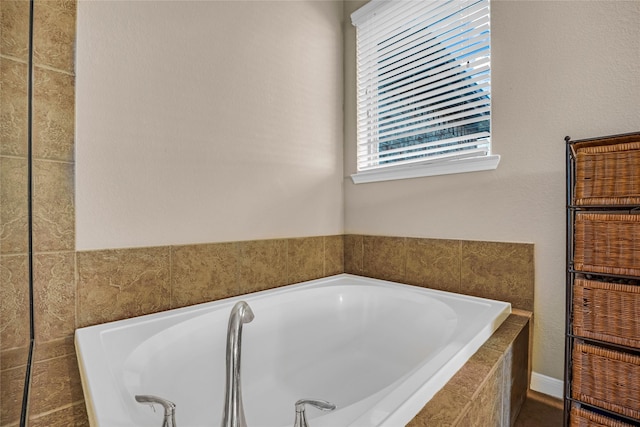 bathroom featuring tiled bath