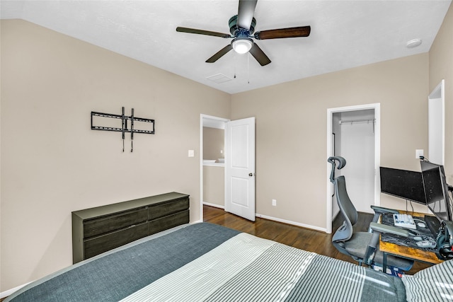 bedroom featuring ceiling fan, dark hardwood / wood-style floors, a spacious closet, and a closet