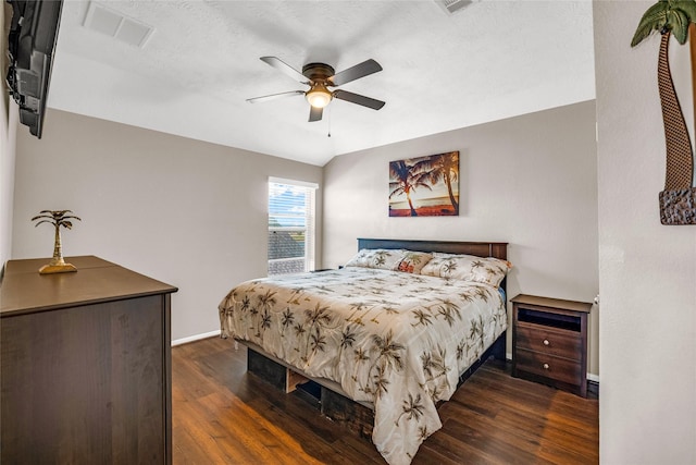 bedroom featuring ceiling fan and dark wood-type flooring