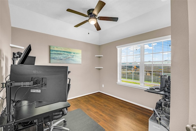 home office with ceiling fan and dark wood-type flooring