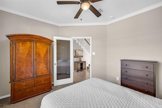 carpeted bedroom featuring french doors, ceiling fan, and ornamental molding