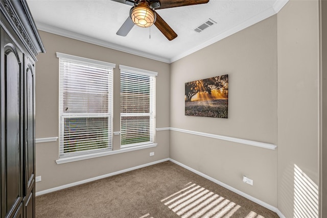 unfurnished room featuring ceiling fan, carpet floors, and ornamental molding