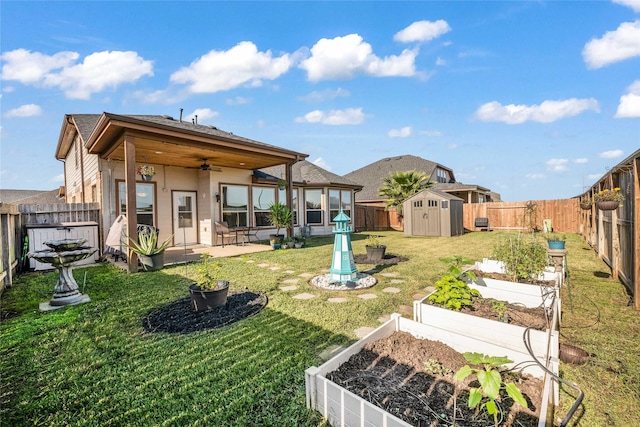 view of yard featuring ceiling fan, a patio area, and a storage shed