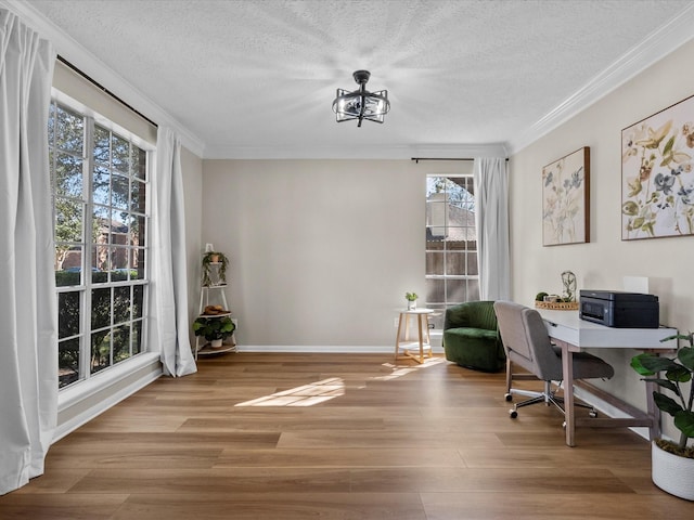 home office with a chandelier, ornamental molding, a textured ceiling, and light hardwood / wood-style flooring