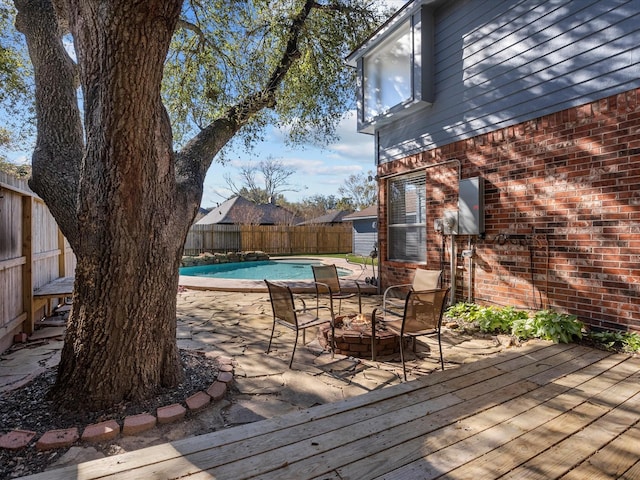 wooden deck featuring a fenced in pool