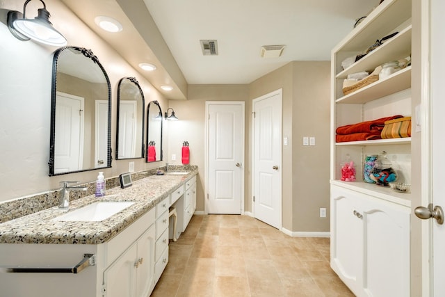 bathroom with tile patterned flooring and vanity