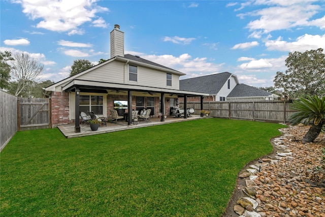 rear view of house with a lawn and ceiling fan