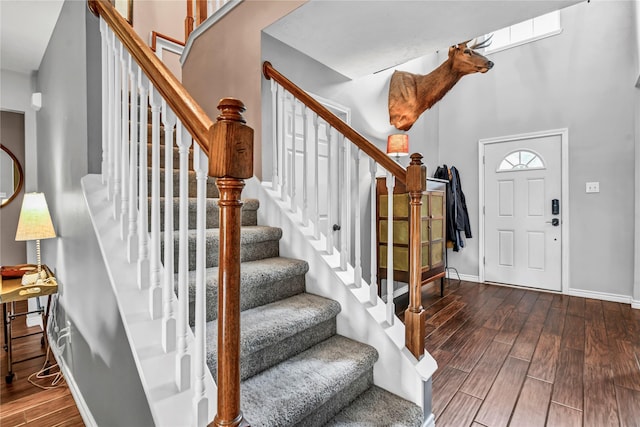 foyer entrance featuring a towering ceiling