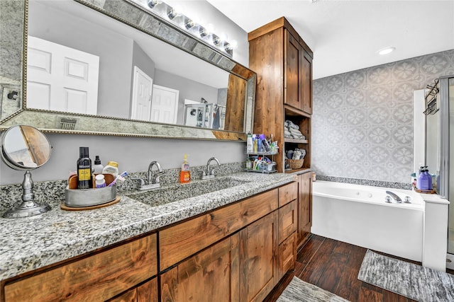 interior space featuring a washtub, hardwood / wood-style floors, and vanity