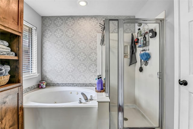 bathroom with shower with separate bathtub and plenty of natural light