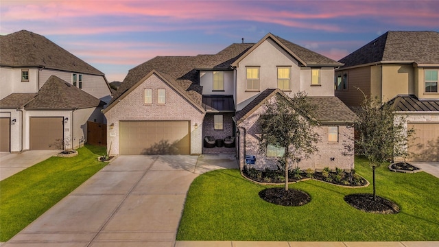 view of front of home featuring a garage and a lawn