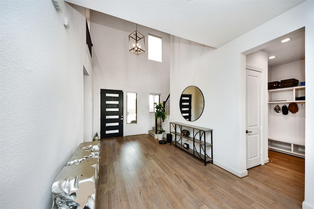 foyer featuring light hardwood / wood-style floors and an inviting chandelier