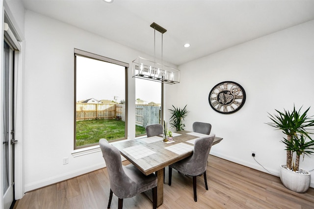 dining area featuring a chandelier and light hardwood / wood-style flooring