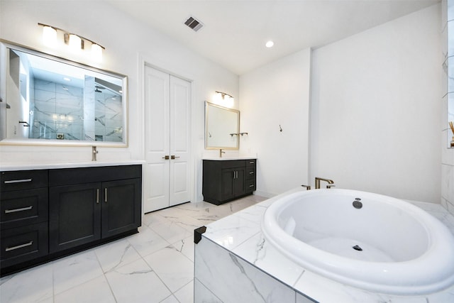 bathroom featuring vanity and separate shower and tub