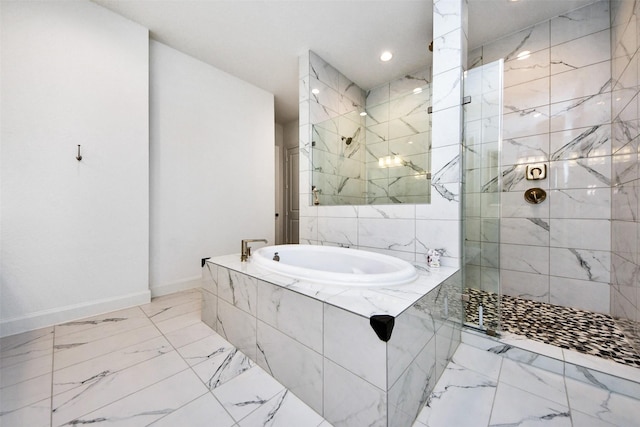 bathroom featuring separate shower and tub