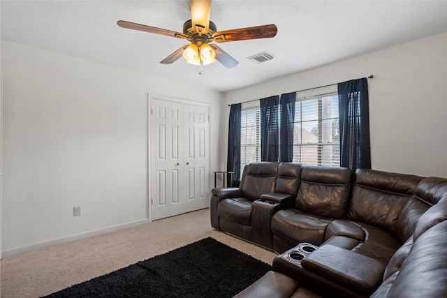 carpeted living room with ceiling fan