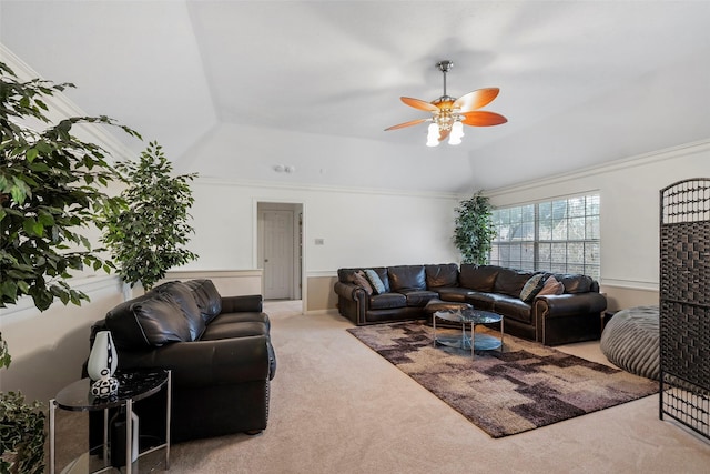 carpeted living room featuring ceiling fan and a tray ceiling