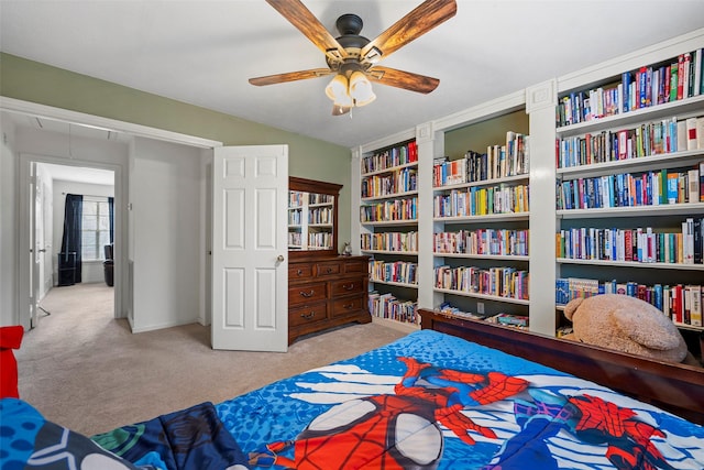 bedroom with ceiling fan and light colored carpet