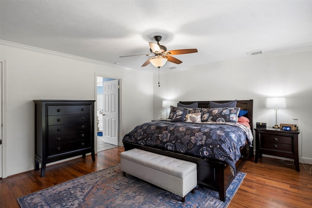 bedroom with dark wood-type flooring, ornamental molding, and ceiling fan