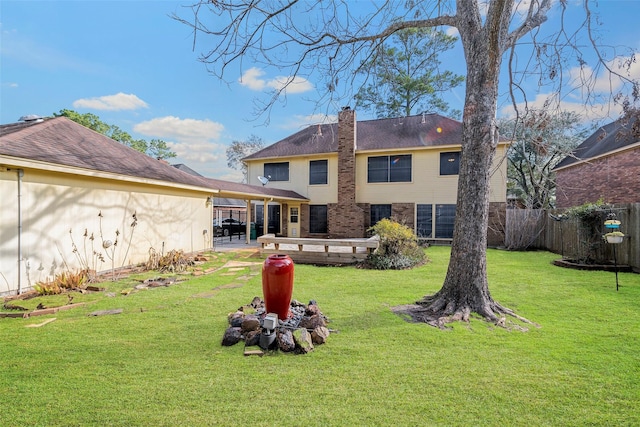 back of property with a patio and a lawn