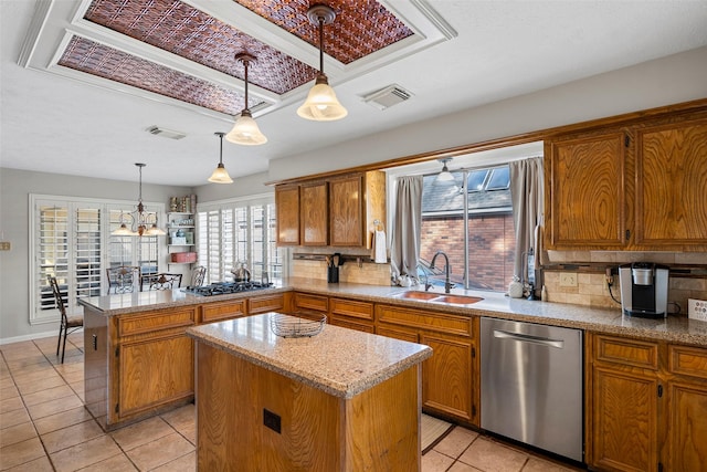 kitchen featuring pendant lighting, sink, stainless steel appliances, and a center island