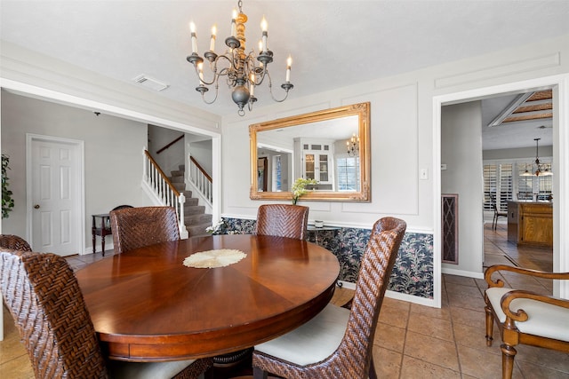 dining area featuring an inviting chandelier and light tile patterned floors