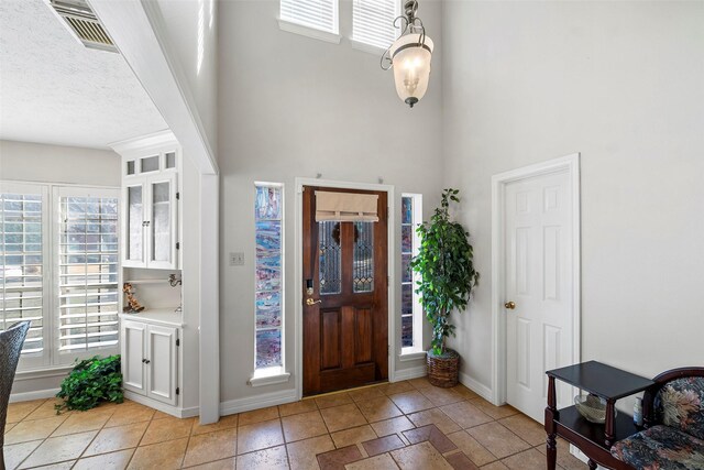 entrance foyer with a high ceiling and a textured ceiling