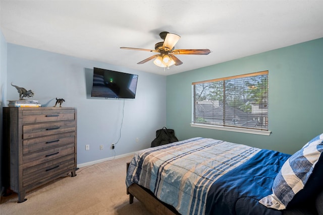 bedroom featuring light carpet and ceiling fan