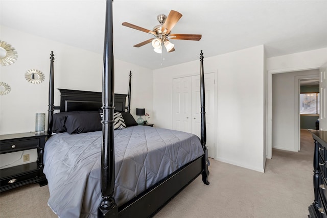 bedroom featuring light carpet, a closet, and ceiling fan