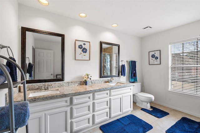 bathroom featuring tile patterned floors, vanity, and toilet