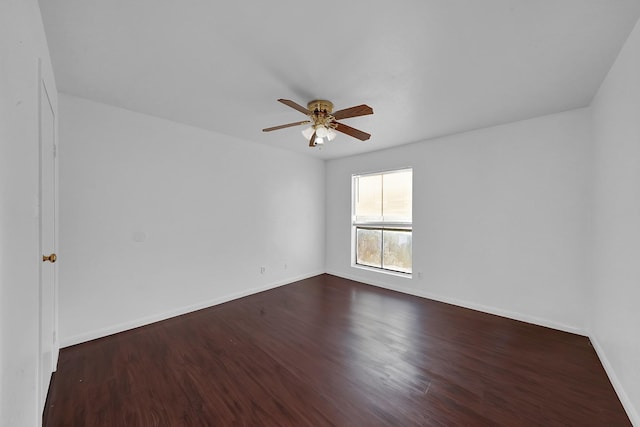 unfurnished room with ceiling fan and dark wood-type flooring