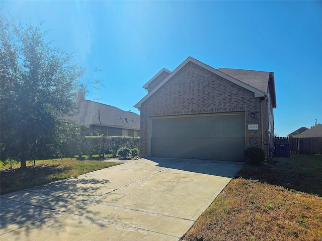 view of home's exterior with a garage and a yard