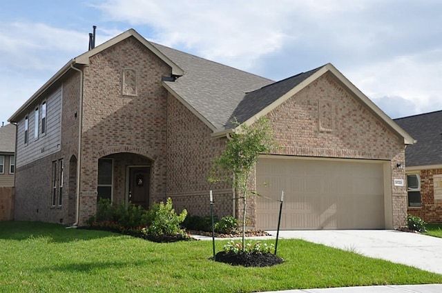 view of front facade with a front yard and a garage