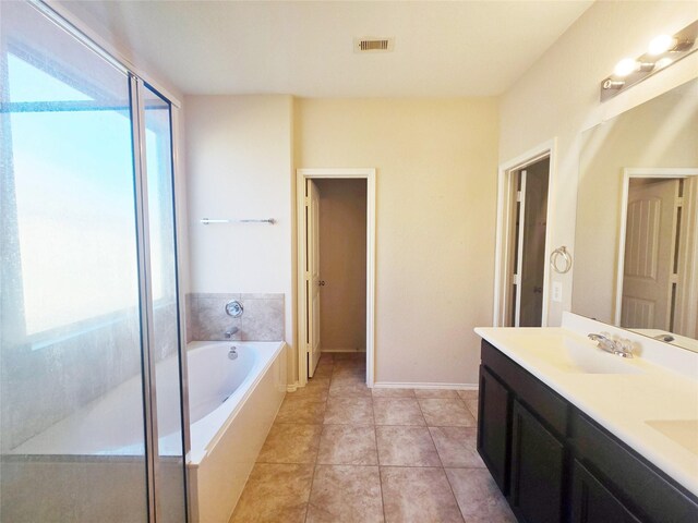 bathroom with tile patterned flooring, vanity, and shower with separate bathtub