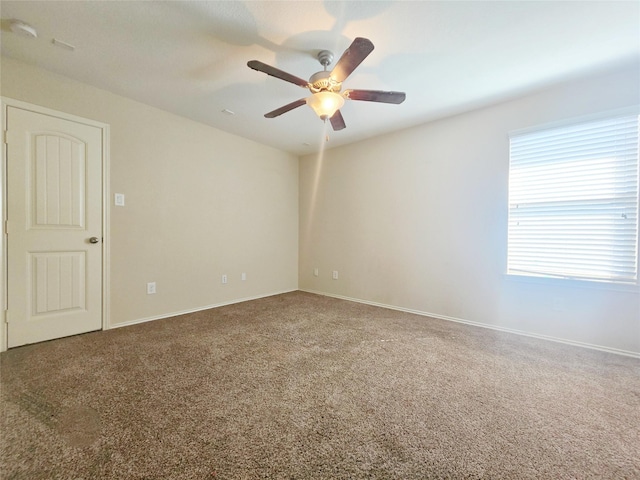 carpeted empty room featuring ceiling fan