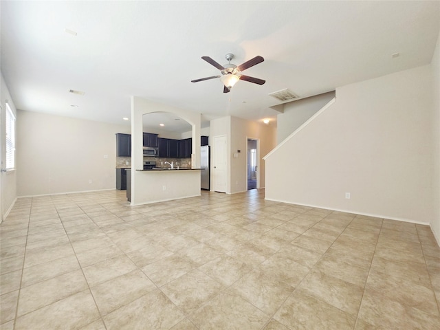 unfurnished living room featuring ceiling fan