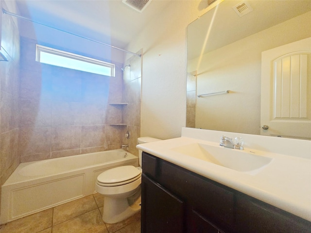 full bathroom with tile patterned flooring, vanity, tiled shower / bath combo, and toilet