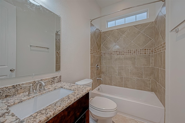 full bathroom featuring tile patterned floors, toilet, vanity, and tiled shower / bath